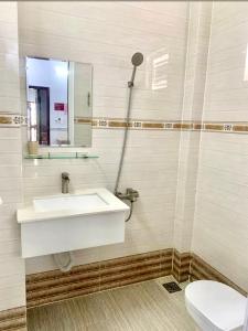 a bathroom with a sink and a toilet at Thuỳ Trang Hotel in Ho Chi Minh City