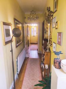 a hallway of a home with a yellow door at Cosy London single room (near Wimbledon) in London