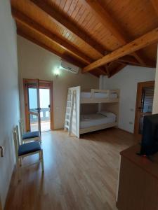 a room with two bunk beds and a chair at Vila Green Relax in Vlorë