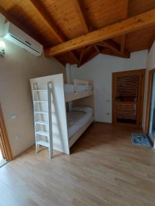 a room with a bunk bed and a wooden ceiling at Vila Green Relax in Vlorë