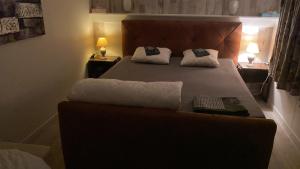 a bedroom with a bed with two pillows on it at Chalet in Lanaken