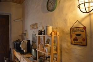 a kitchen with a counter and a clock on the wall at B&B MAMAOH in Fondi