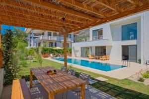 an external view of a villa with a swimming pool at Villa İon İndoor heated pool, Sauna, Jacuzzi, Underfloor heating system in Fethiye