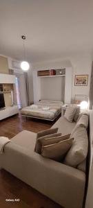 a living room with two beds and a couch at Relax&Business Velletri Centro in Velletri