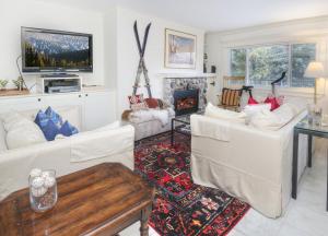 a living room with white furniture and a fireplace at Vantage Point #307 condo in Vail