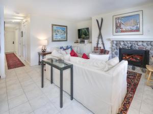 a living room with a white couch and a fireplace at Vantage Point #307 condo in Vail