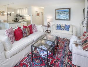 a living room with two couches and a glass table at Vantage Point #307 condo in Vail