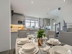 a kitchen with a table with plates and wine glasses at 3 Bed in Durham 94762 in Lanchester