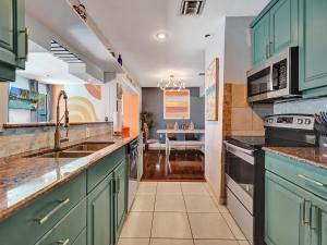 a kitchen with green cabinets and a sink at Large GAY MEN'S 1 bedroom w Gameroom heated pool clothing optional in Fort Lauderdale