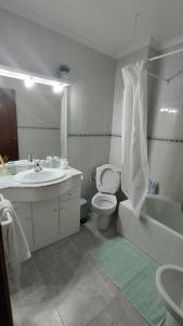 a bathroom with a sink and a toilet and a tub at Sea view apartment, first line on the beach, Remote work in Canet de Berenguer