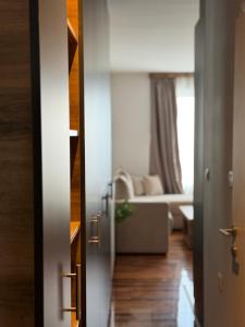 a door leading into a living room with a couch at VEMA 2 Apartments in Belgrade