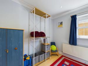 a room with a shelf and a blue door at 12A Solent Landing direct beach access in Bembridge