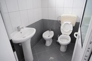 a bathroom with a toilet and a sink at Hotel 'DEL MAR' - Shengjin in Shëngjin