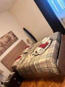 a bedroom with a bed with a plaid comforter at Casa Xenia in Trieste