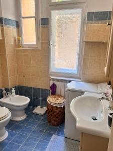 a bathroom with a toilet and a sink at Casa Xenia in Trieste