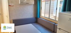 a small room with a bench next to a window at Campsitechalet in Viareggio near sea incl airco in Viareggio