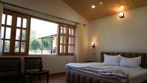 Postel nebo postele na pokoji v ubytování Saanjh Cottages + 29 fotografií