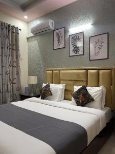 a bedroom with a large bed with white pillows at Safari Hotel in Islamabad
