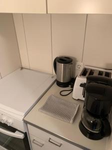 a kitchen counter with a coffee pot on a stove at Panoramahaus Apartment 7152 in Bad Reichenhall
