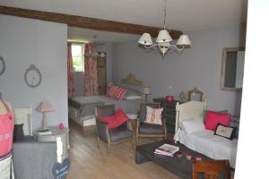 a living room with a bed and a couch at La Maison du Potager de Mazières in Sainte-Solange