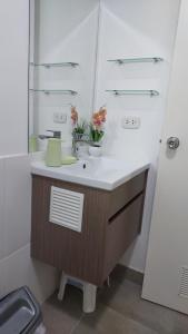a bathroom with a sink and a mirror at Apartamento Varela in Lima +16 photos