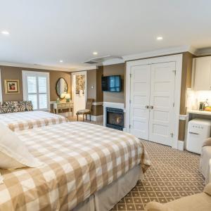 a bedroom with two beds and a fireplace at Mary's Land Farm in Ellicott City