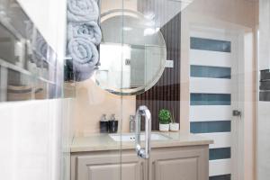 a bathroom with a sink and a mirror at Jazuri Villa in Buccoo