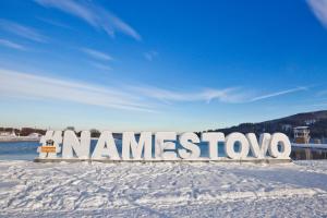 a sign that says namestwo in the snow at Unique Boat Apartments by Lake - Kajuta 1958 in Námestovo