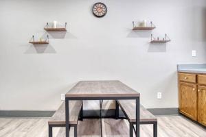 a table in a room with a clock on a wall at Artistic 1br - Apt - Near Downtown & Mass Ave in Indianapolis