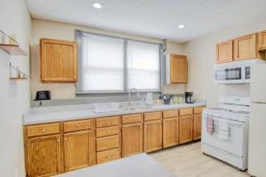 a kitchen with wooden cabinets and a white appliance at Artistic 1br - Apt - Near Downtown & Mass Ave in Indianapolis