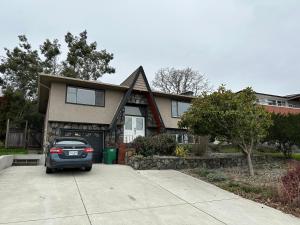 a car parked in front of a house at Modern Cozy Home W Free Parking- Close to Downtown & Beach in Victoria