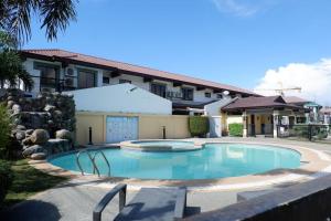 a swimming pool in front of a building at Whitehaus Courtyards 11 E in Cagayan de Oro