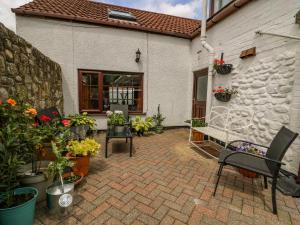 a patio with a bunch of flowers and plants at Rhodale Cottage in Barmston