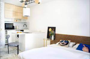 a bedroom with a bed and a kitchen at Majestic Apartment in Cannes +4 photos
