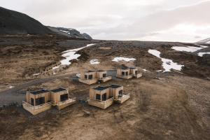 an aerial view of four houses in a field at Dis Cottages in Grundarfjordur