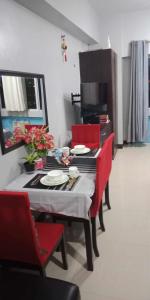 a kitchen with a table with red chairs and a dining room at CP19P TWINBED COZY ROOM Near at Venice Mall in Manila