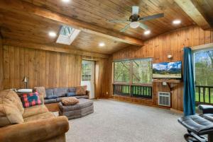 a living room with a couch and a ceiling fan at Fairway to Heaven on Beech in Beech Mountain