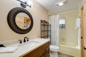 a bathroom with a sink and a toilet and a mirror at Fairway to Heaven on Beech in Beech Mountain +21 photos