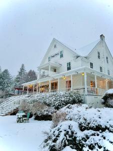 a large white house with snow on it at Orcas Hotel in Orcas