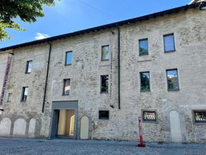 an old brick building with its door open at LaViDaViò Suite Room in Bergamo