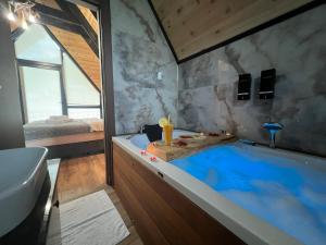 a bathroom with a large blue tub in it at Aquarium BUNGALOW UZUNGÖL in Uzungöl