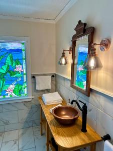a bathroom with a sink and a stained glass window at Orcas Hotel in Orcas +46 photos