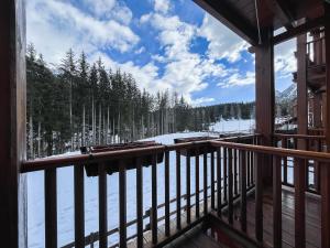 a view from the balcony of a cabin with snow at Maison Poluc hotel apartments in Champoluc