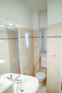 a bathroom with a toilet and a sink at Apartma Mariella in Piran +9 photos