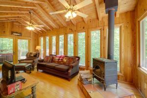 a living room with a couch and a stove at Cataloochee Ski Day Trips! Hot Tub Haven in Marion in Marion