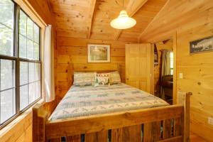 a bedroom with a bed in a log cabin at Cataloochee Ski Day Trips! Hot Tub Haven in Marion in Marion