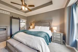 a bedroom with a large bed and a ceiling fan at Platte City Retreat with Patio, Near Kansas City! in Platte City
