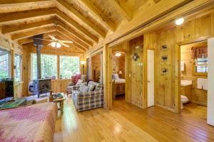 a log cabin living room with wooden walls and wooden floors at Hike, Soak and Unwind in Nature Blue Ridge Cabin in Marion