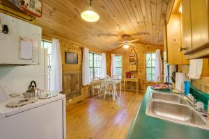 a kitchen with wooden walls and a wooden floor at Hike, Soak and Unwind in Nature Blue Ridge Cabin in Marion