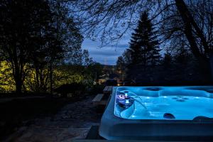 a blue bath tub sitting next to a tree at Balsam House in Baraboo